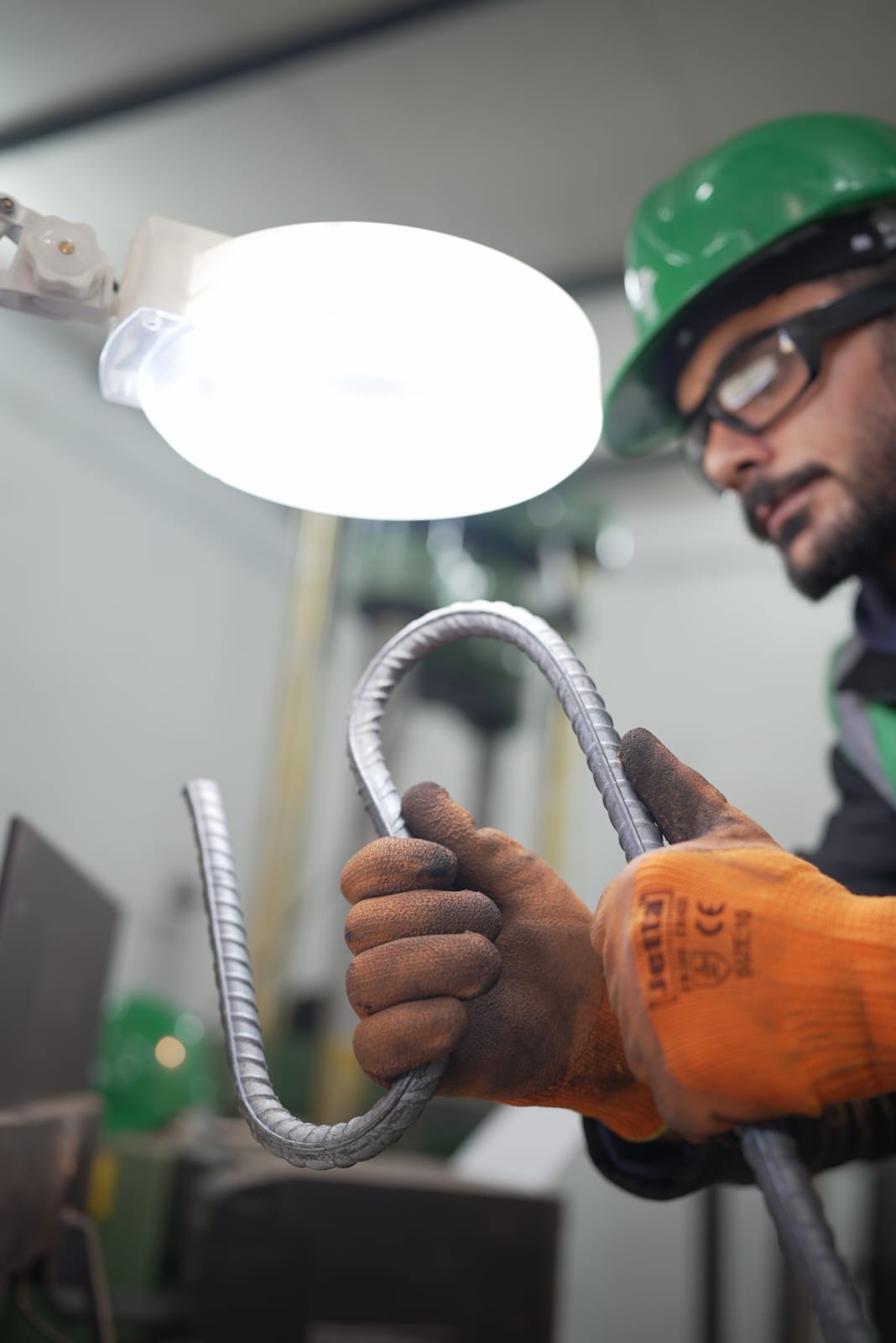 Sabaeek quality technician inspecting a bent rebar sample