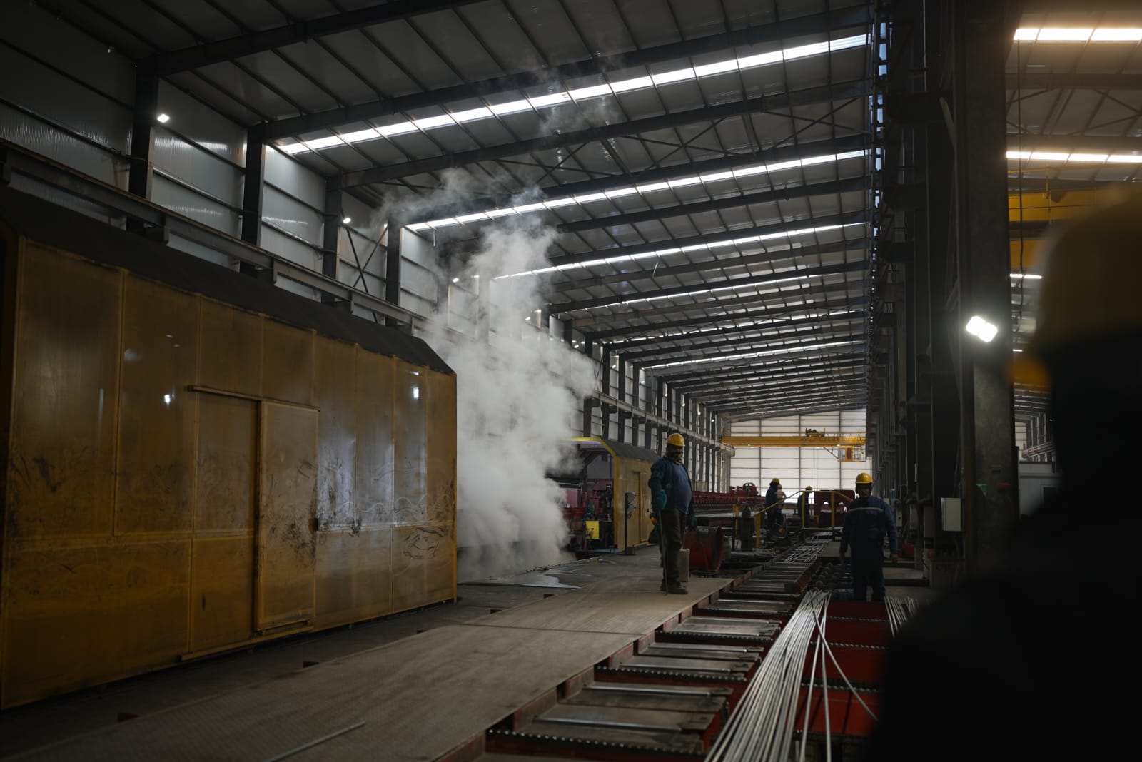 Worker loading rolled rebar coils