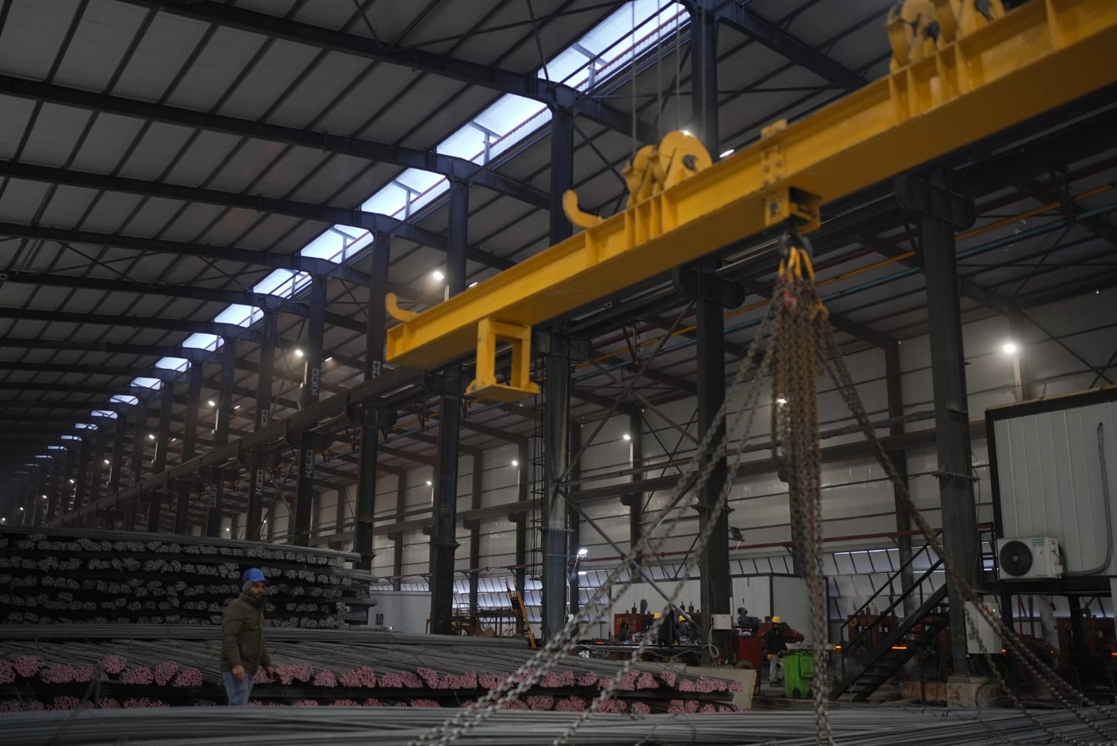 Overhead crane above bundled rebar in the Sabaeek storage yard